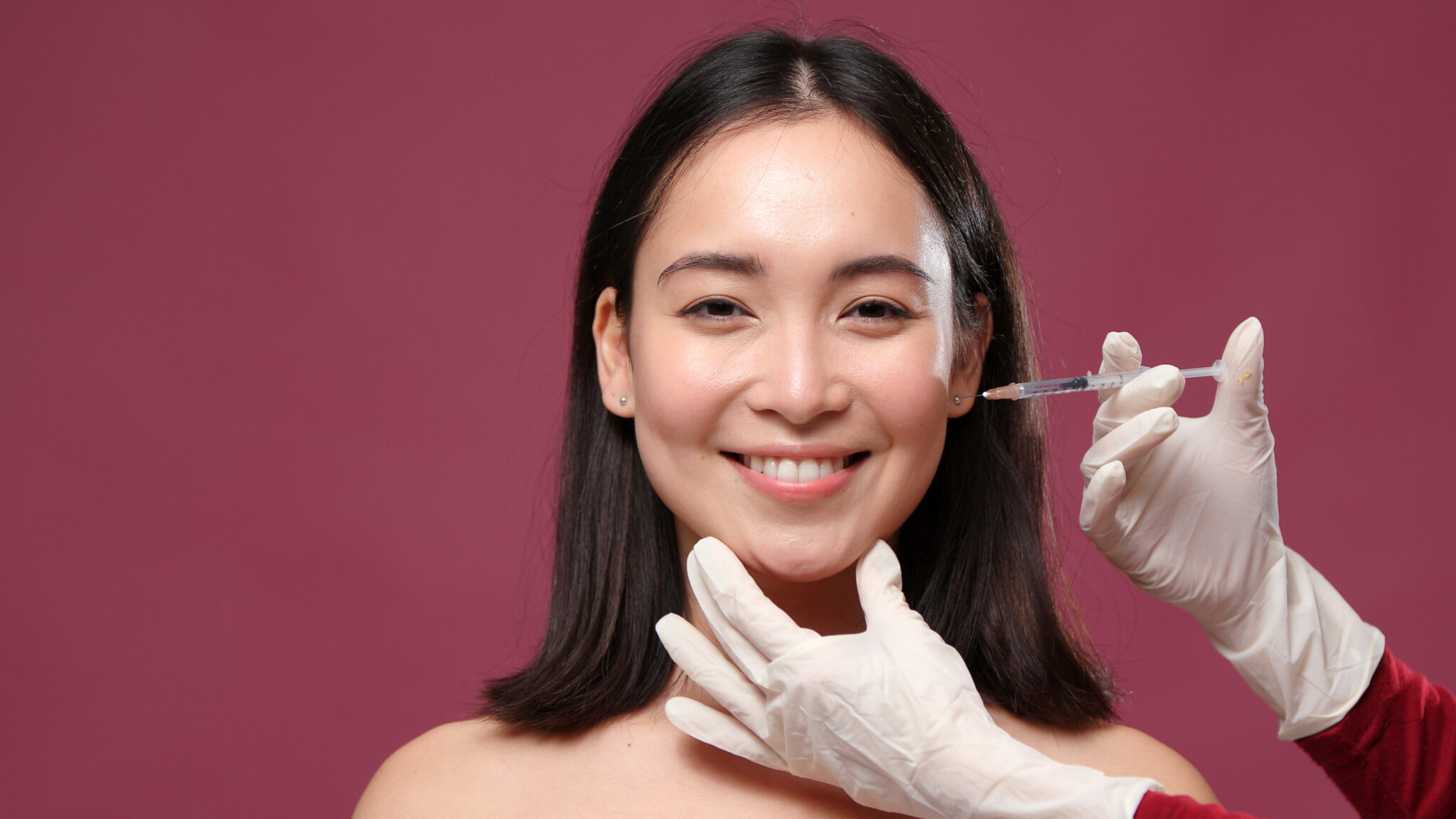 Young asian woman happy of anti wrinkle doctor in glove try to give injection on her face for anti wrinkles injections