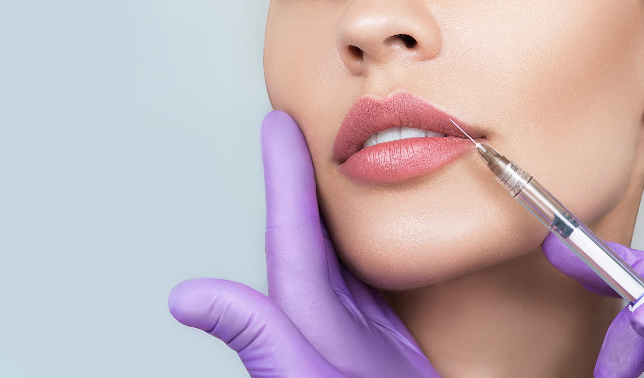 a lady accepting dermal fillers from our dermal fillers specialist