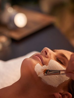 A woman enjoying a Bionutriglow rejuvenation face mask treatment, embracing the refreshing sensation for radiant and revitalized skin