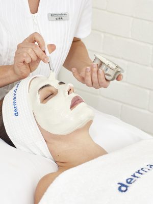 A woman enjoying a bespoke facial treatment, embracing the personalized experience for glowing and rejuvenated skin.